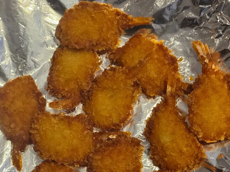 Breadcrumbed butterfly prawns, golden and crisp