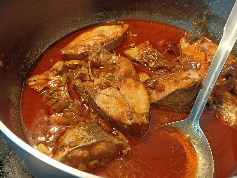 Fish steaks simmering in a deep red Tamil Nadu tamarind curry
