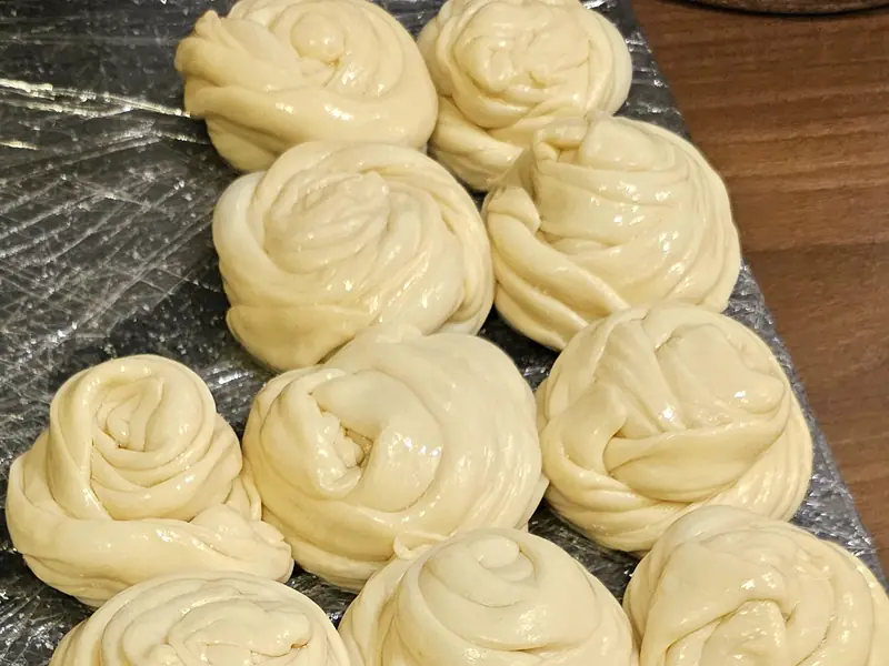 Rows of coiled parotta dough waiting to be rolled